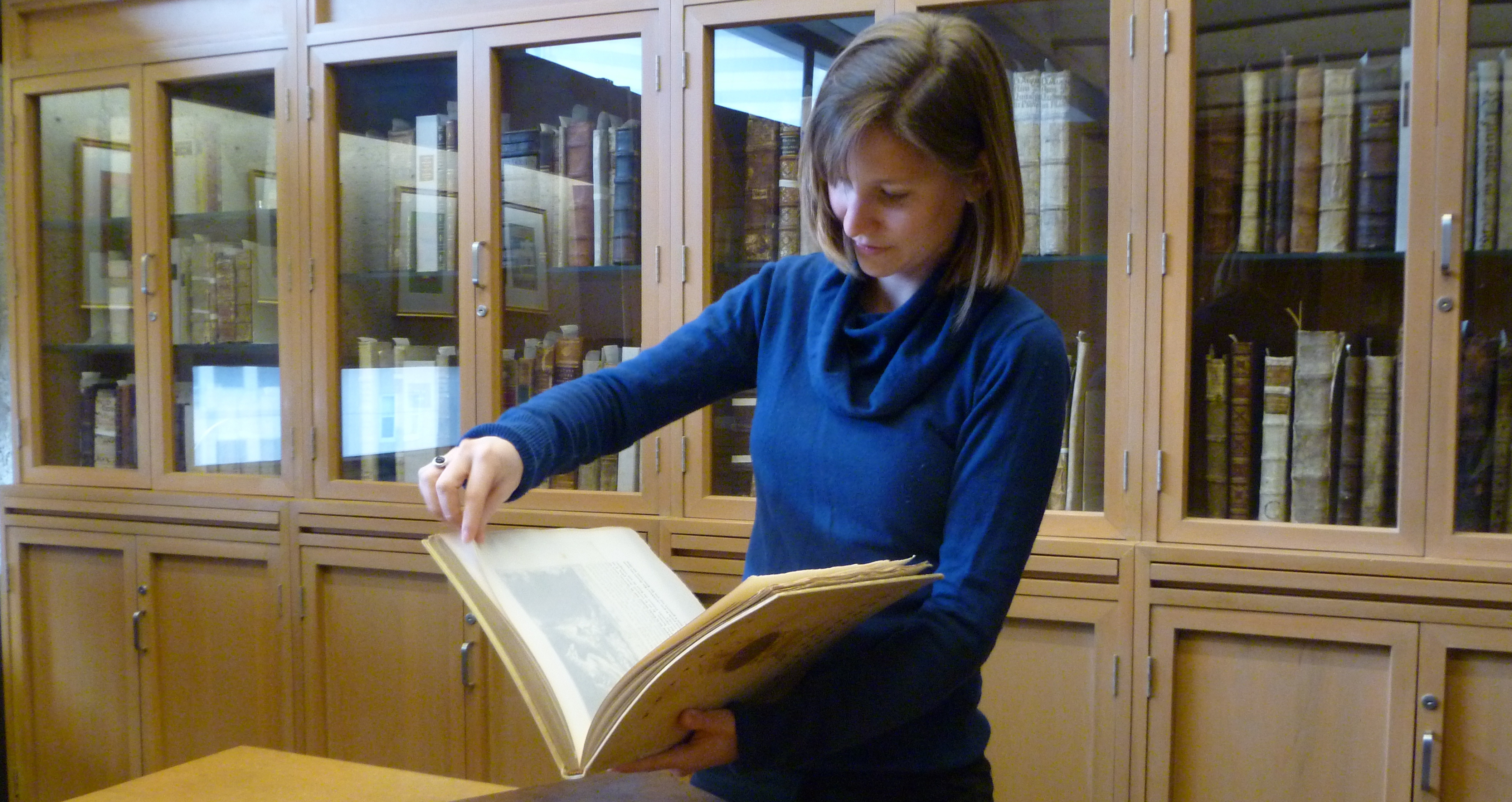 Enssib intern Élise Breton working with rare material, Rare Books & Special Collections Library.