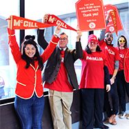 Image of McGill staff holding archival flags/ promotional materials