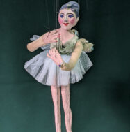 ballerina string puppet on a green backdrop
