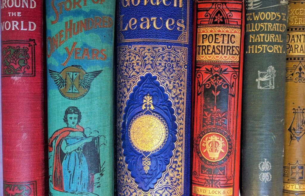 Close-up of five colourful rare books.