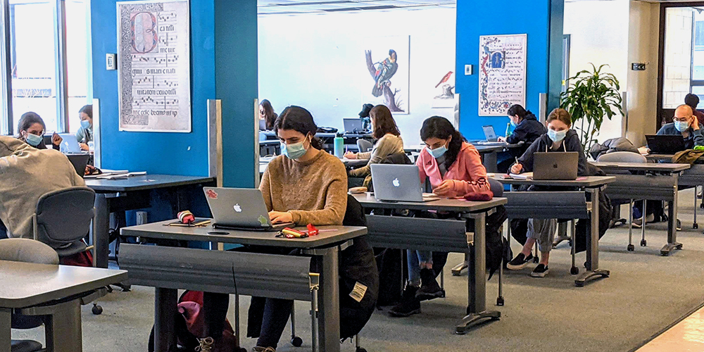 Students at desks in Study Hub wearing masks.