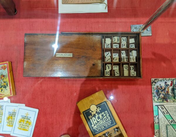 alphabet tiles and games in display case