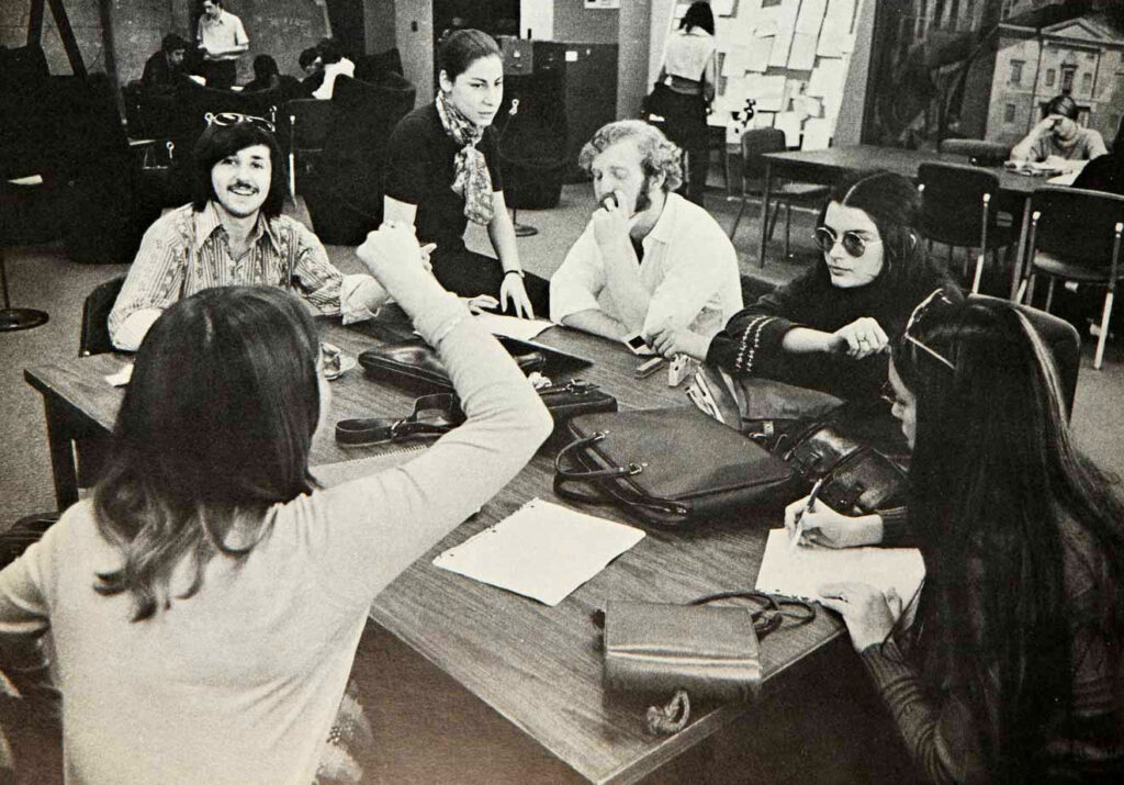 Black and white 1970s archival photo of students at a Library table.