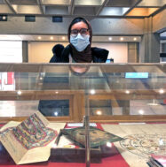 Student worker Labiba Faiza in front of exhibition case