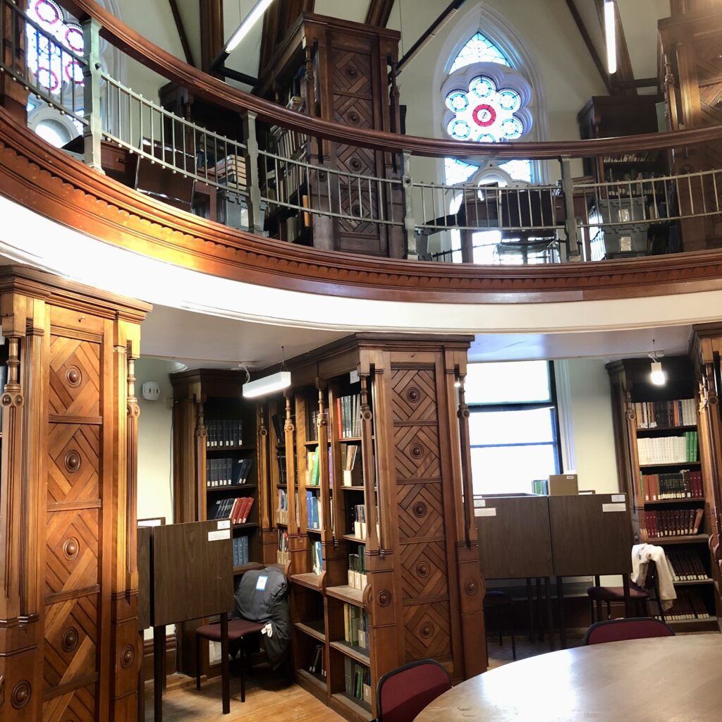 Octagon Room featuring wood panels and stained glass windows.