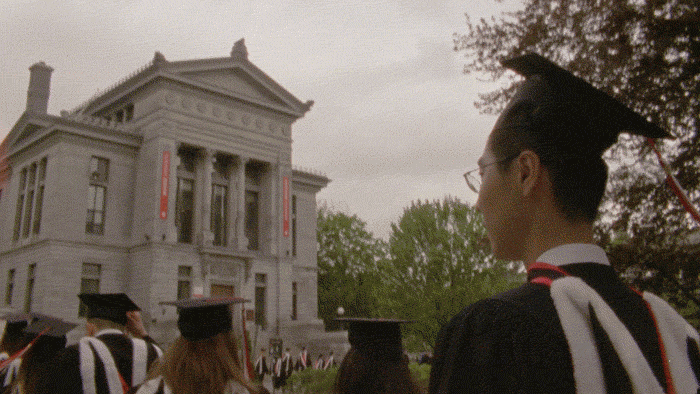 GIF featuring grads in caps and gowns walking on the McLennan-Redpath Terrace.