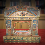 Foregound: toy theatre from McGill's rare and special collections. background Rare Books Reading Room.
