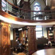 Octagon Room featuring wood panels, bookshelves, and stained glass.