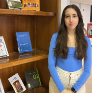 Olivia Melanson next to Redpath Book Display