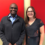 Mutugi Gathuri and Clara Turp smiling at the camera in front of red panels.