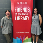 Award winners Julia Couture and Sara-Alba Gonzalez Pepe with a red Friends of the Library banner.