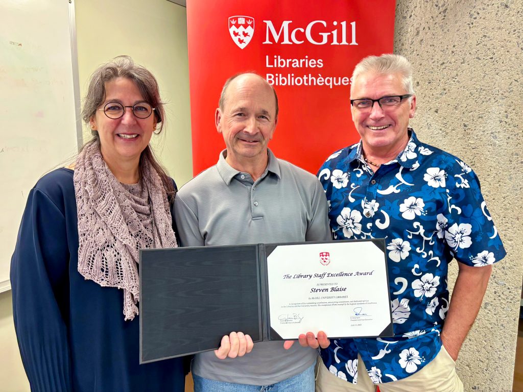 From left to right: Dean Guylaine Beaudry, Steve Blaise, and Robert Selby (nominator) smiling in front of a red banner.