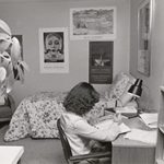 Black and white photo of student studying in the a dorm room in the 1970s..