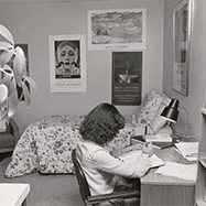 Black and white photo of student studying in the a dorm room in the 1970s..